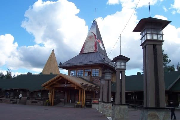 A wooden building beneath a pointed roof at the Arctic Circle