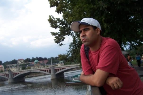 Gagan leaning on a riverside railing