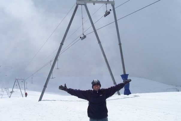 Gagan standing with open arms on a snowy mountain