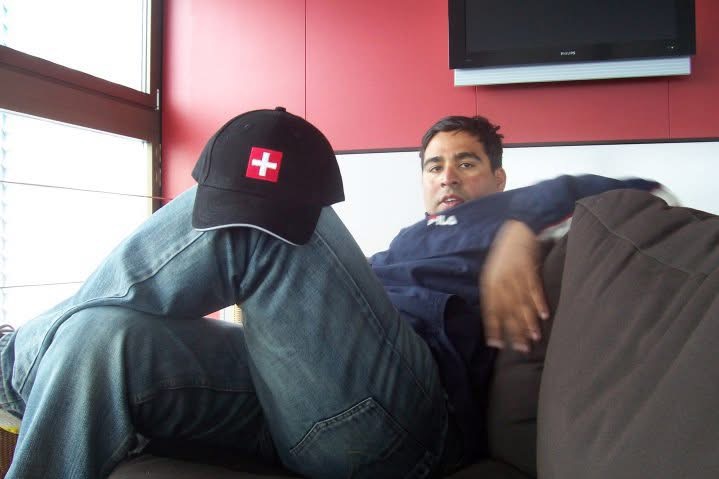 Gagan taking a break indoors with a Swiss-cross cap