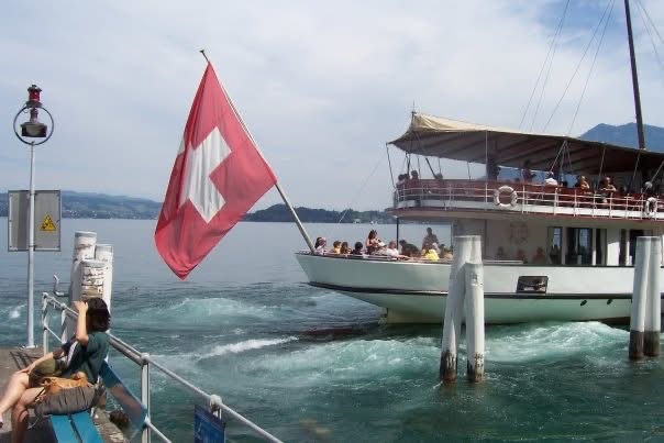 A Swiss-flagged passenger boat on a lake