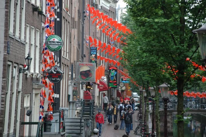 A flag-lined canal street in Amsterdam