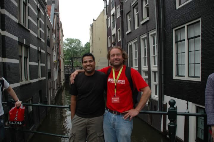 Gagan with a fellow traveller beside an Amsterdam canal
