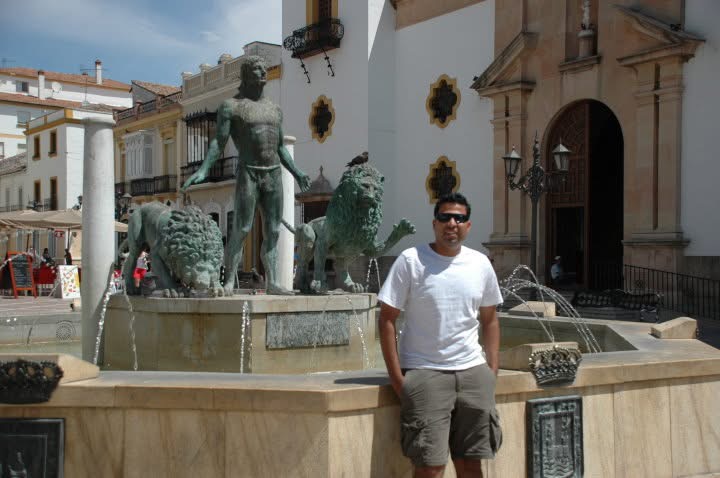 Gagan beside a fountain with statues and lions