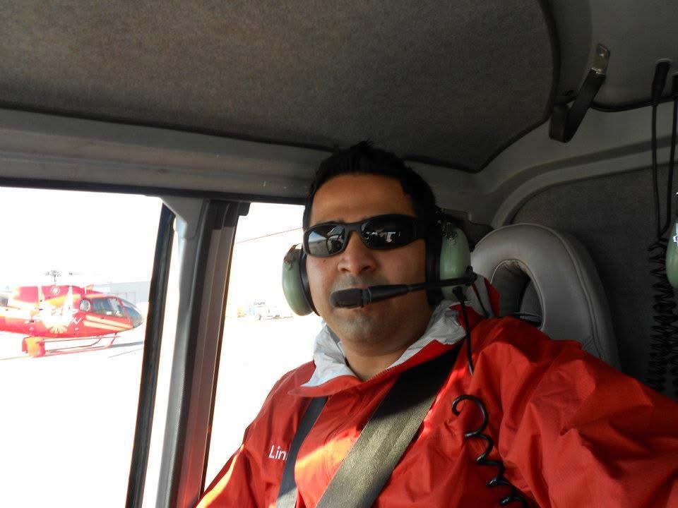 Gagan seated in the helicopter wearing a headset