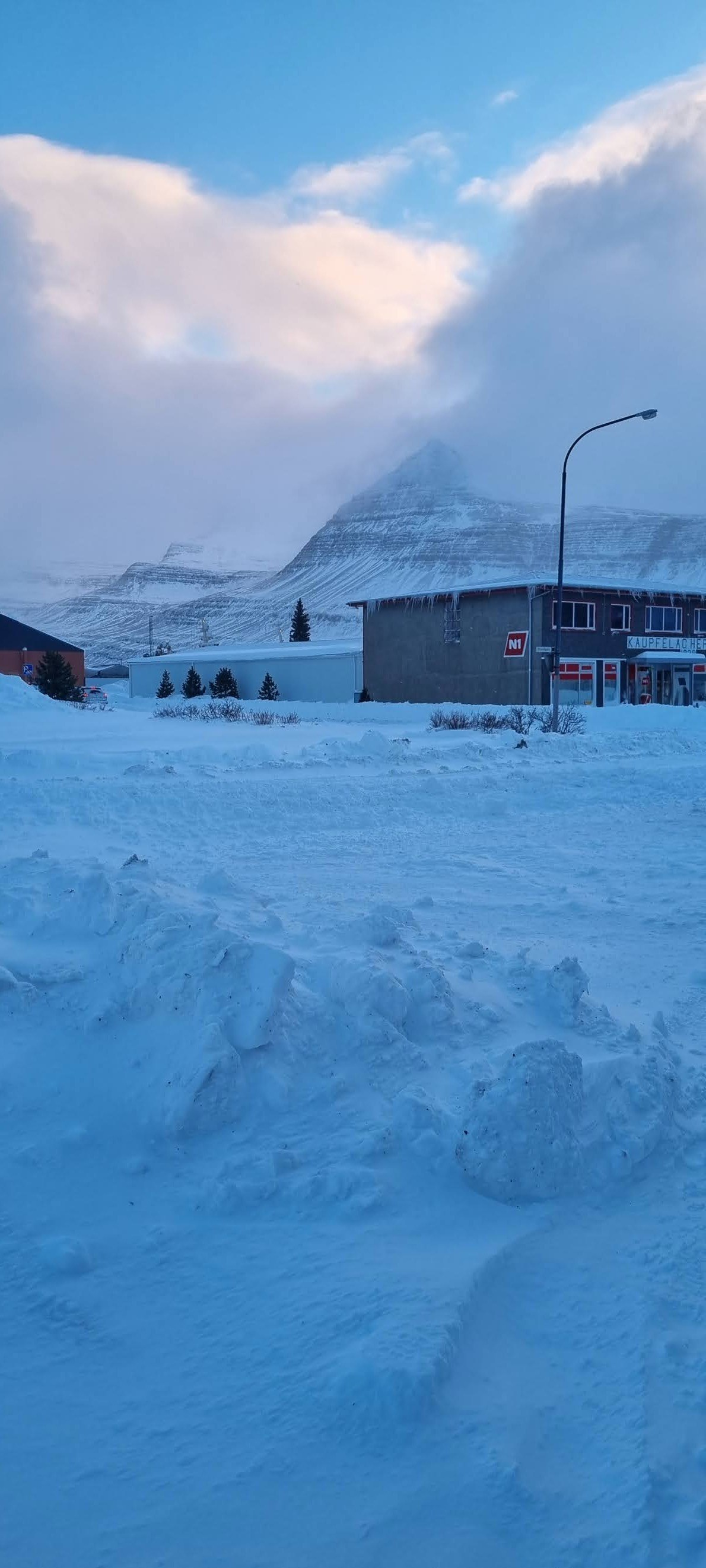Snow and mountains beyond a small town