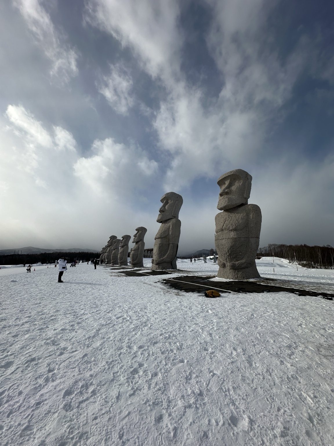 Stone figures standing in a snowy landscape
