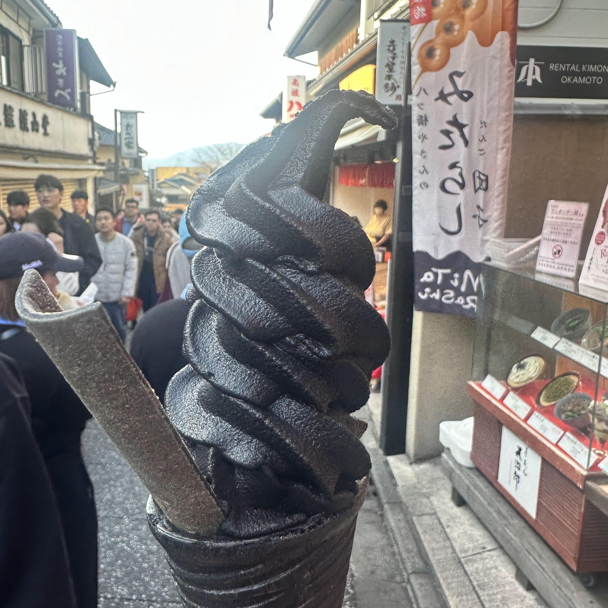 Black soft serve ice cream on a city street