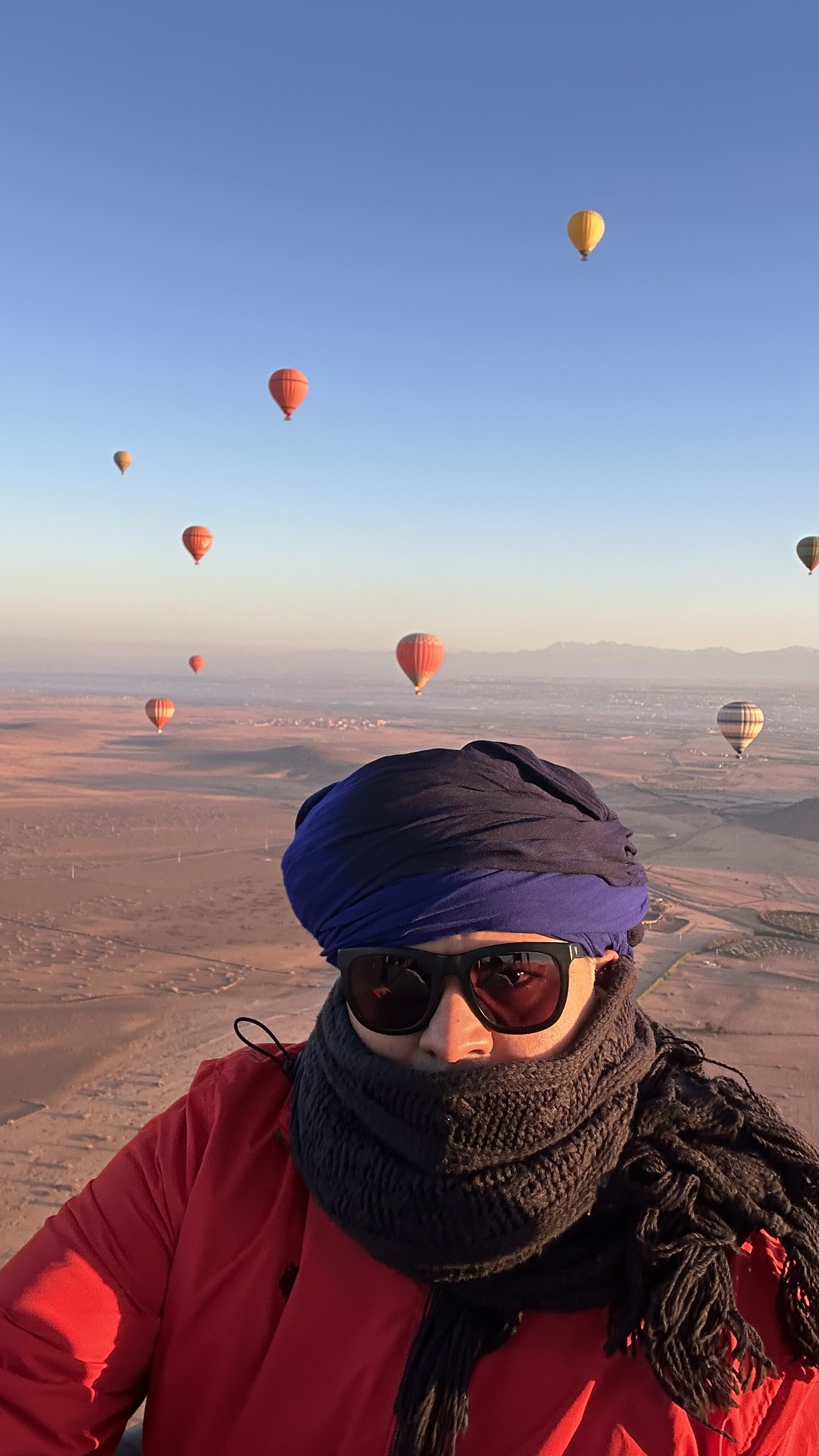 Gagan in a hot-air balloon with others floating across the distant sky