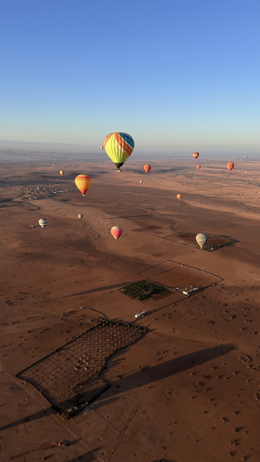 Colourful hot-air balloons floating over Morocco in morning light