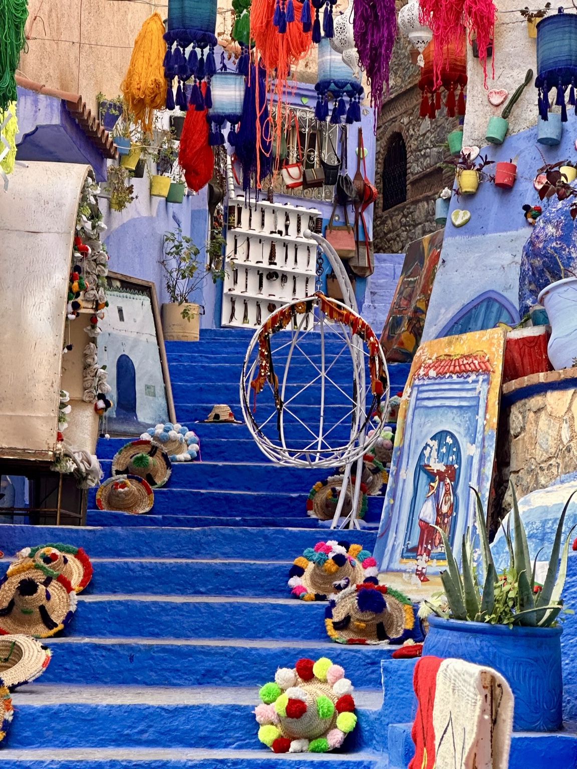 Blue steps surrounded by colourful market crafts