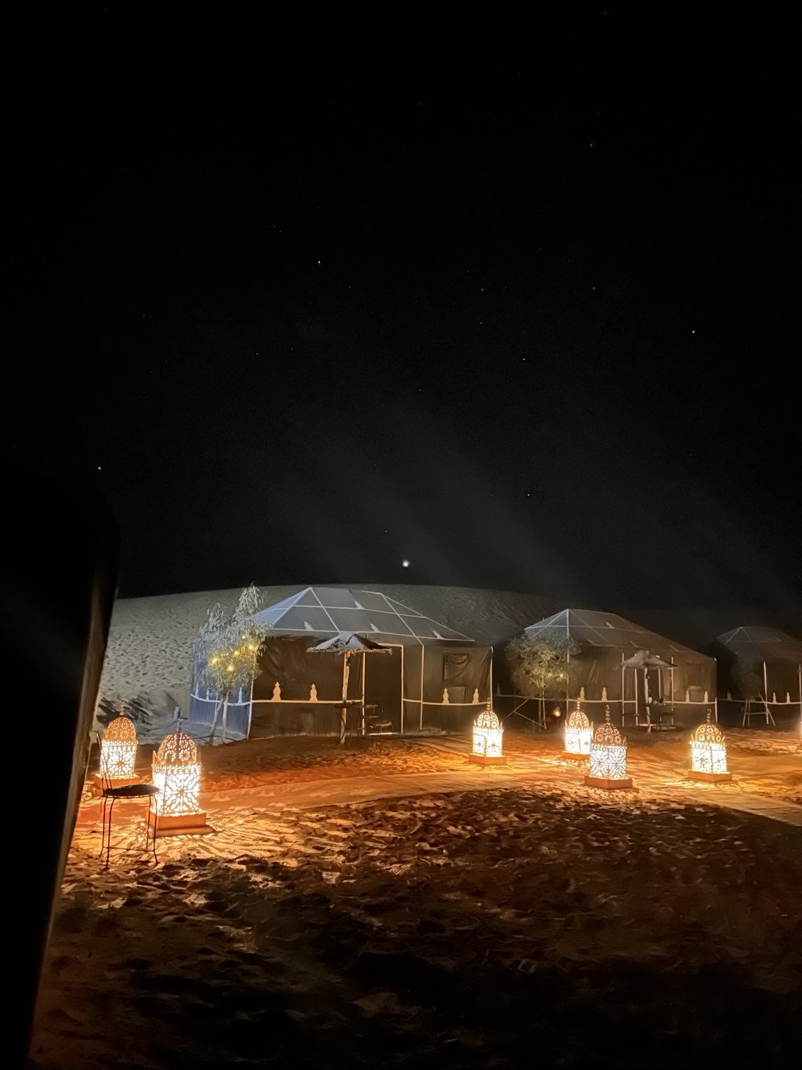 Sahara tents and glowing lanterns under the night sky