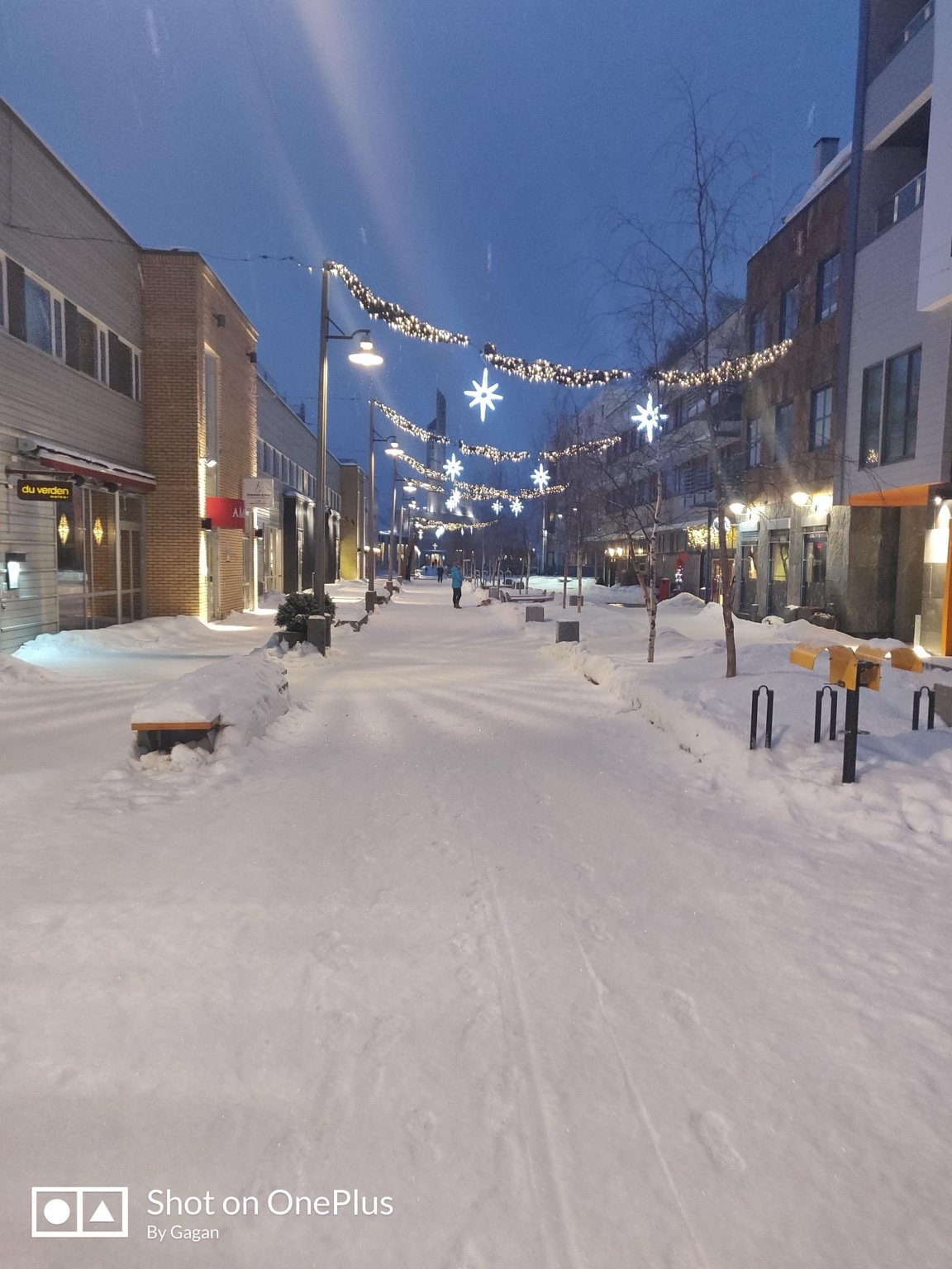 Snowy Norwegian street with festive lights