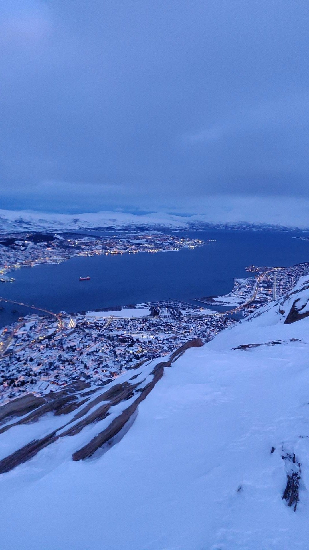 A snowy city beside a fjord
