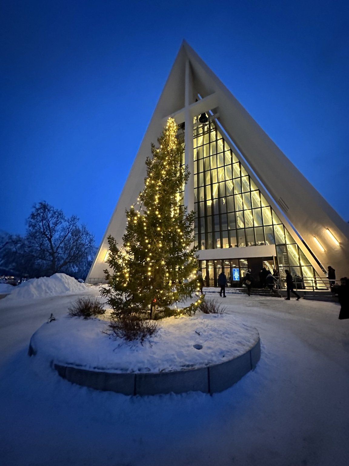Lit triangular building in the snow