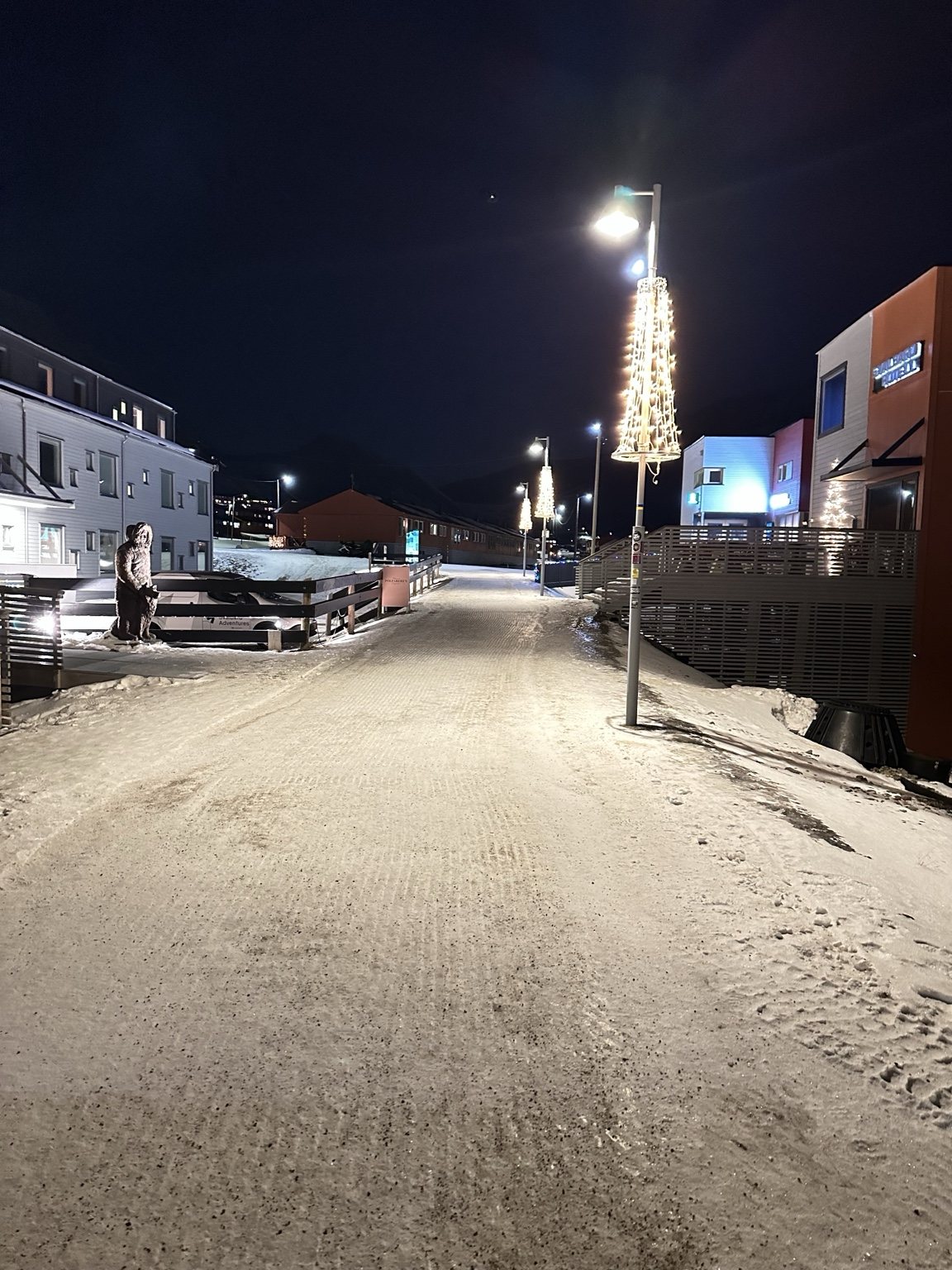 Snow-covered street and lights in a Svalbard town